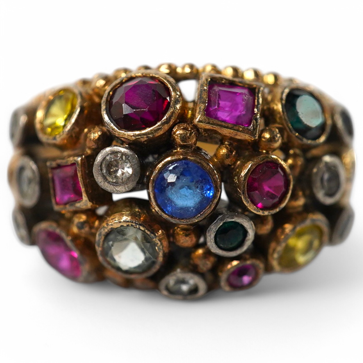 A 1940's continental yellow metal and multi gem set cluster dress ring, size P, gross weight 6.6 grams. Condition - poor to fair